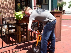 Chad Becker, owner of Your Chauffeur, folds bike for easy transporting
