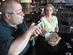Chris documents his Founders Grandwich while sponsor and JGR Real Estate coworker Elaine Williams looks on