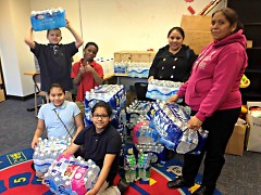 Local families and their students collect water at Harrison Park for Flint