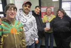 Liz accepts the donation from Brent, Michael, Brett, and Felicia for the KVO/CBOT Toys for Tots drive.