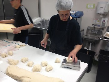 Lisa Barhydt weighing out each portion of dough to 4 oz.