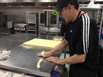 René Pascal Kalter hand-rolling the bagel dough.