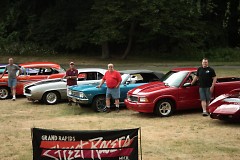 Grand Rapids Street Racers members pose in front of their cars.