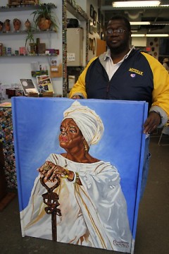 Tommie with a painting of Maya Angelou