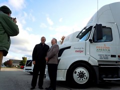 Feeding America West Michigan CEO Ken Estelle poses with Doug Meijer, whose company donated three trucks.