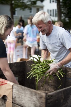 Volunteers give away asparagus by the handful at Parkview Elementary School's Mobile Pantry in July.