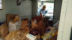 A letter carrier unloads donations from her postal vehicle, Saturday, May 13.
