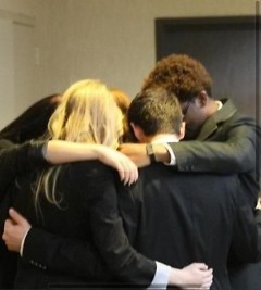The team praying before presenting to the judges.