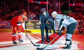 A Salvation Army Officer with the official puck drop at a Griffins game in 2018.