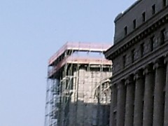 A closer look at the scafolding surrounding tower.