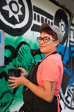 Kimberly Lavon working on her mural in the Baxter neighborhood
