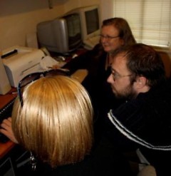 Preston works on computer projects with Well House staff members.