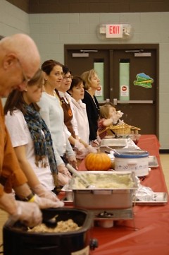 Saint Stephens volunteers serving a delicious Thanksgiving meal to Boys & Girls Clubs.
