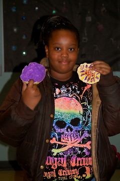 Seidman Club member Pareiah Buggs displaying two of her ceramic pieces in the exhibit.